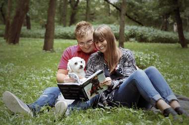 couple does baby photoshoot with dog