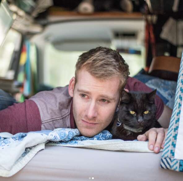 guy and cat travel together