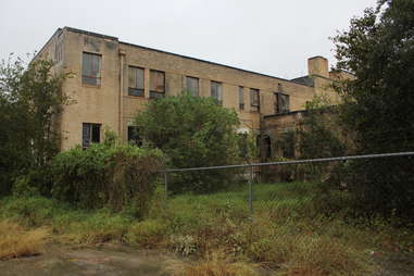 an abandoned, overgrown hospital 
