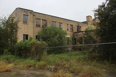 an abandoned, overgrown hospital