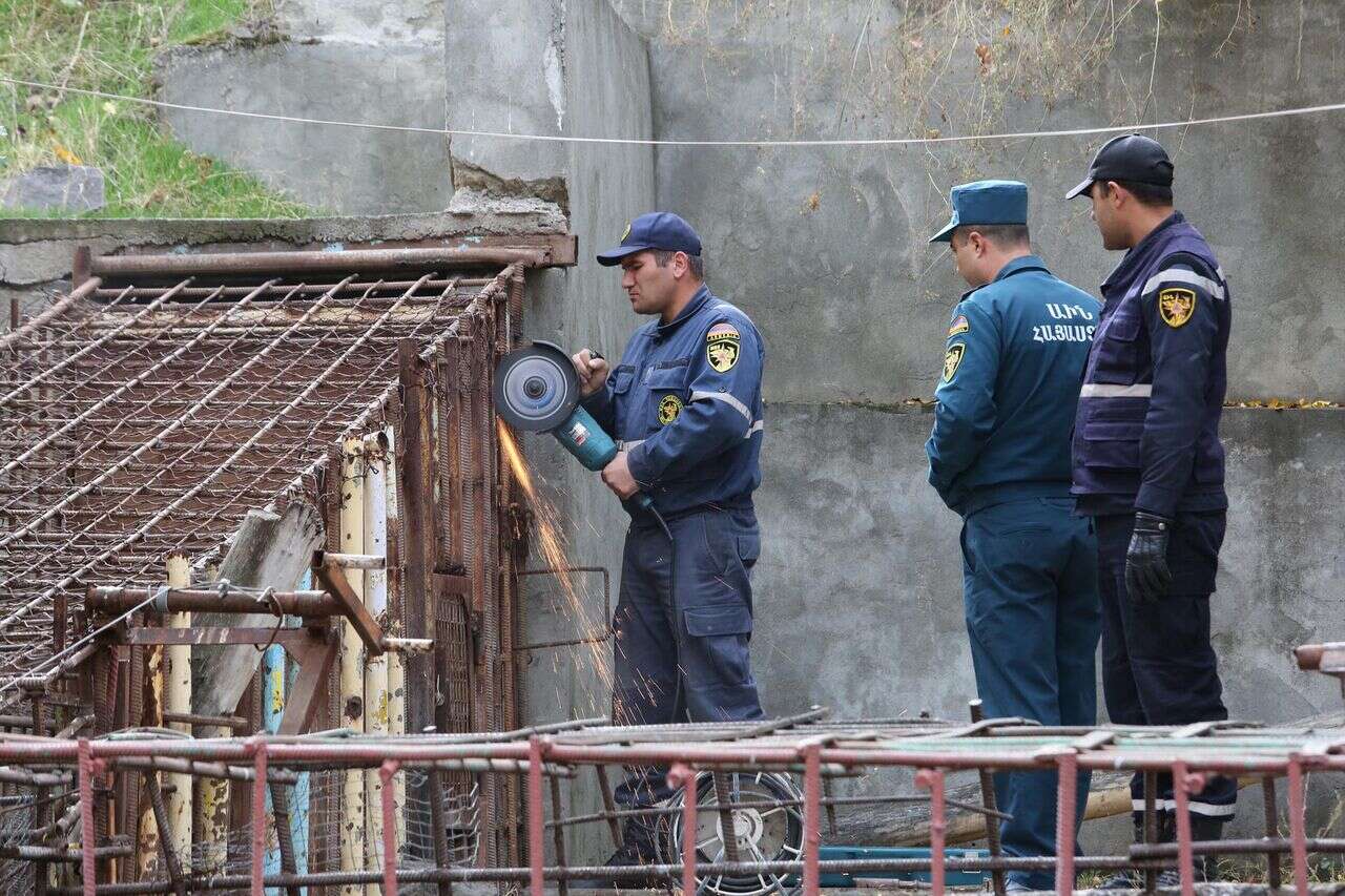 Rescuers sawing through the metal cage of the bears