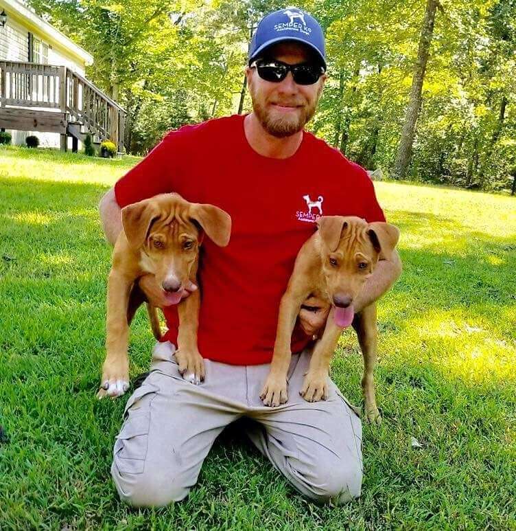 Christopher Baity with two service dogs
