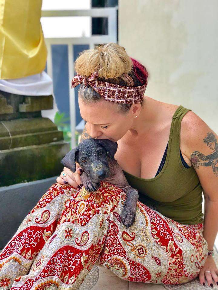 Woman kissing rescued dog in Bali, Indonesia