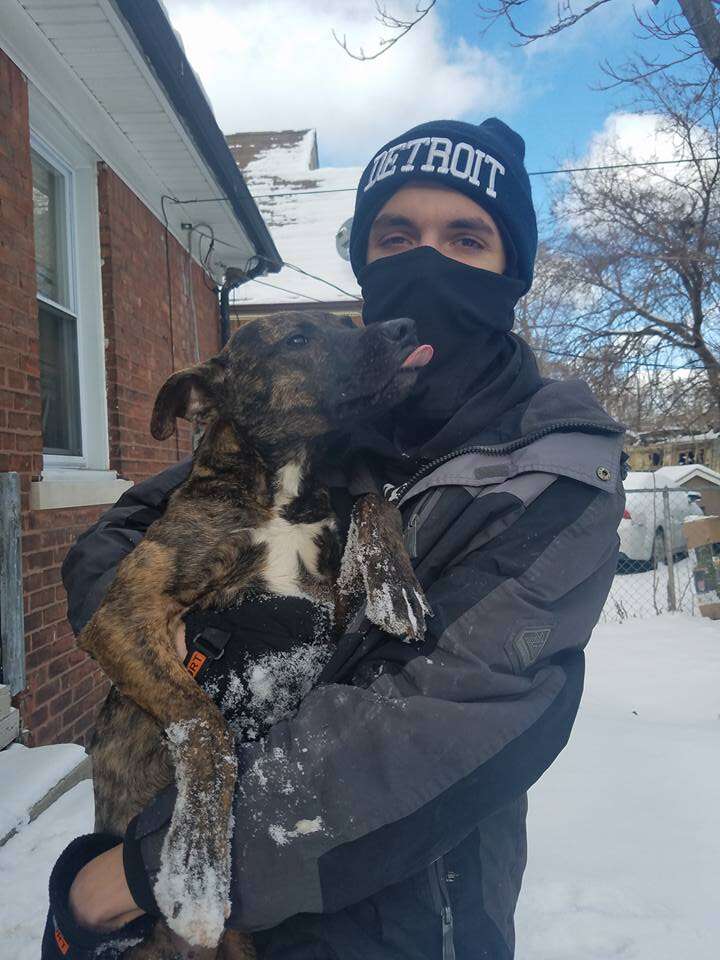 Man holding dog with frostbite