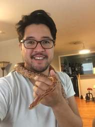 Man with snake around his neck