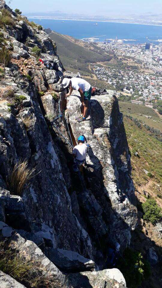 Climbers descending cliff in South Africa
