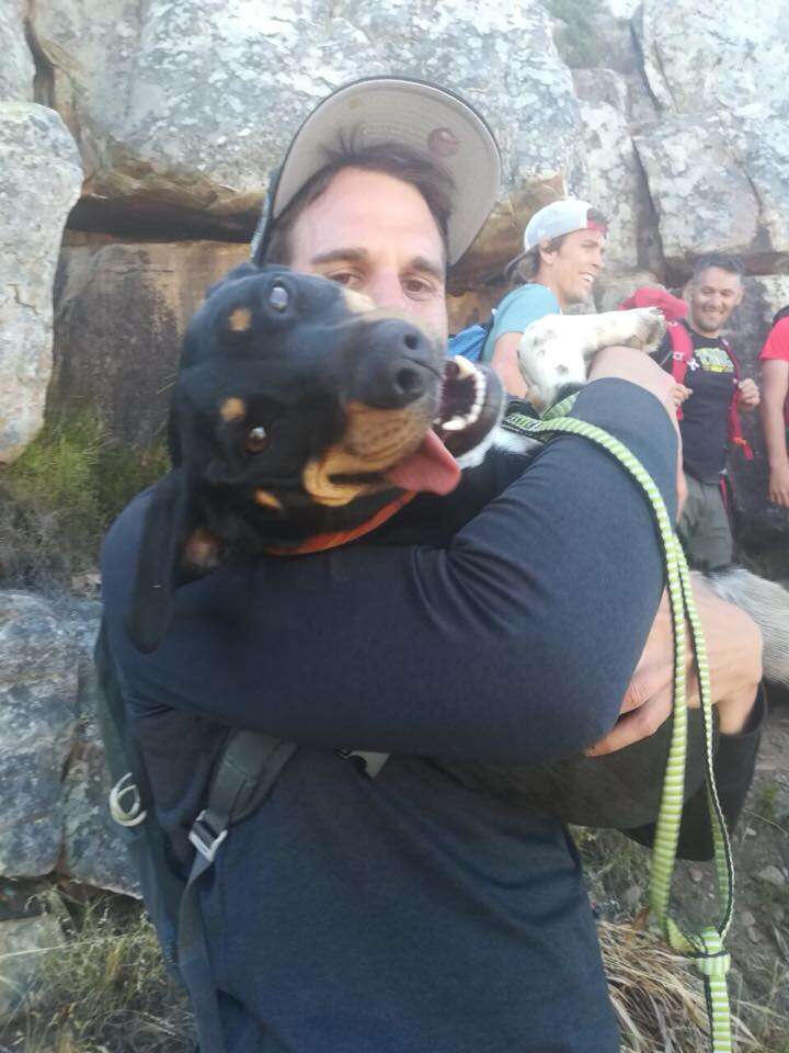 Holly being held by man after being rescue