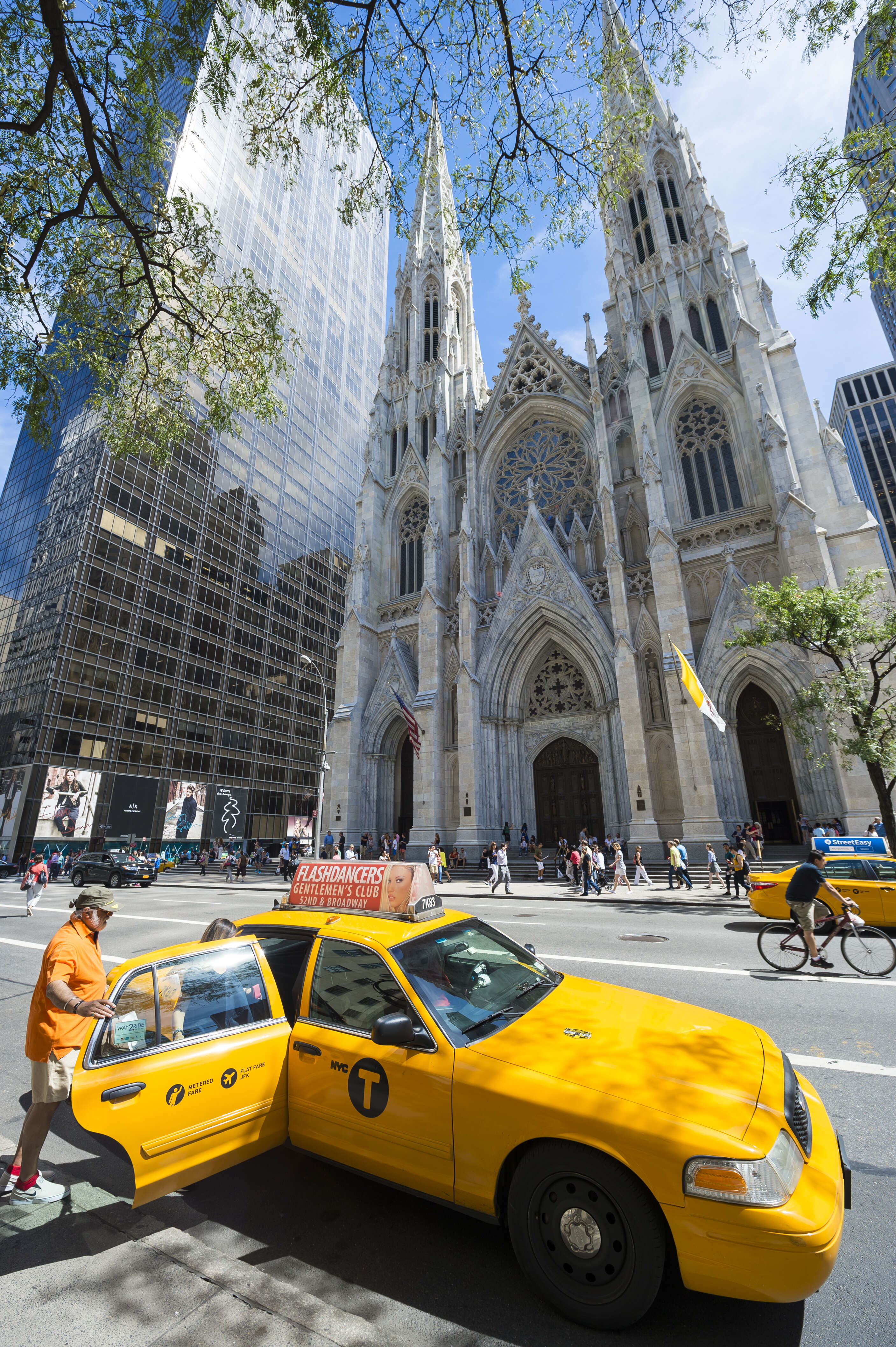 A man gets into a yellow taxi in New York City