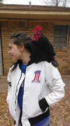 Rooster sitting on little girl's shoulder