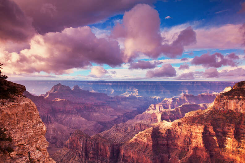 a view out across an enormous canyon at sunrise