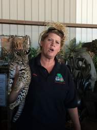 Woman holding big cat at roadside zoo