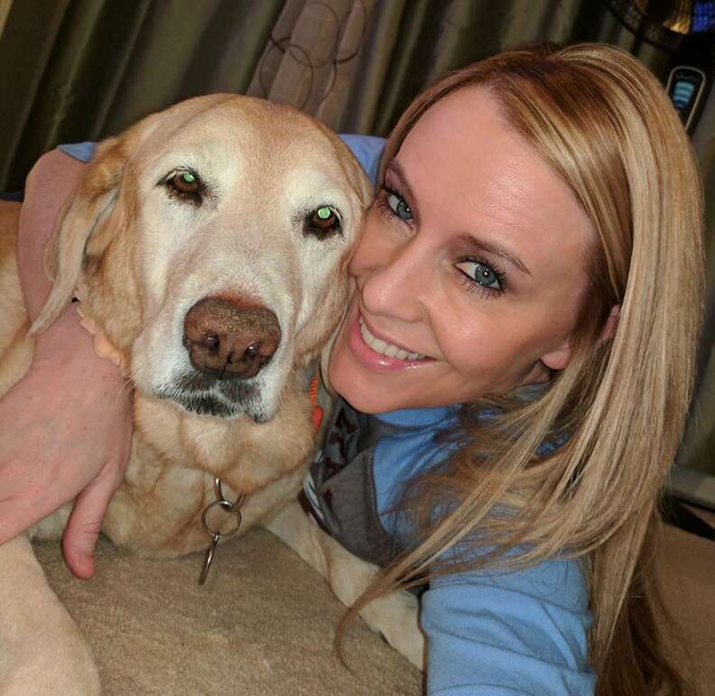 Woman hugging yellow lab