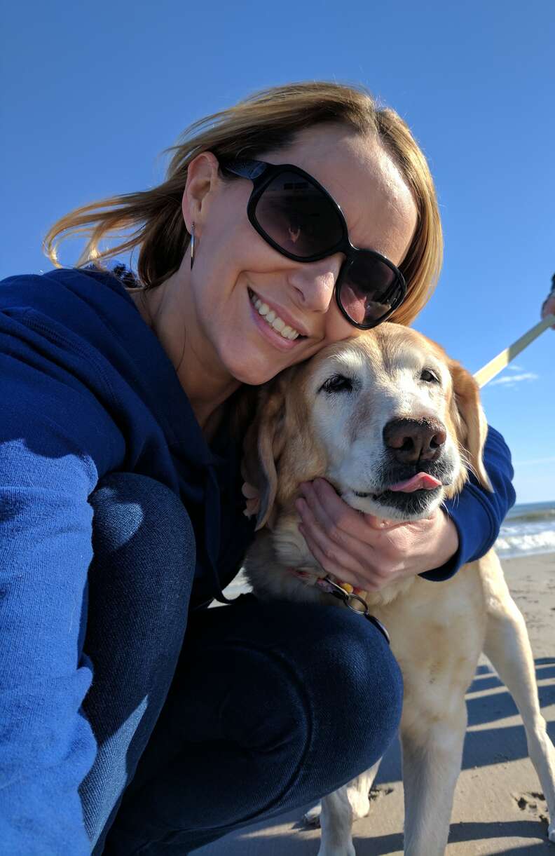 Woman hugging yellow lab