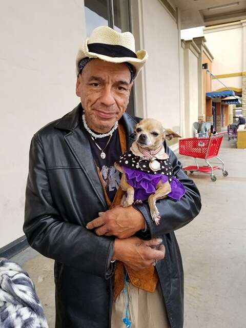 Homeless man holding dog