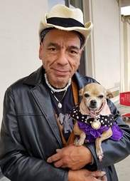 Homeless man holding chihuahua