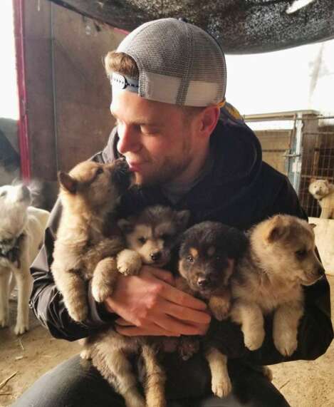 Olympic skier holding rescued puppies