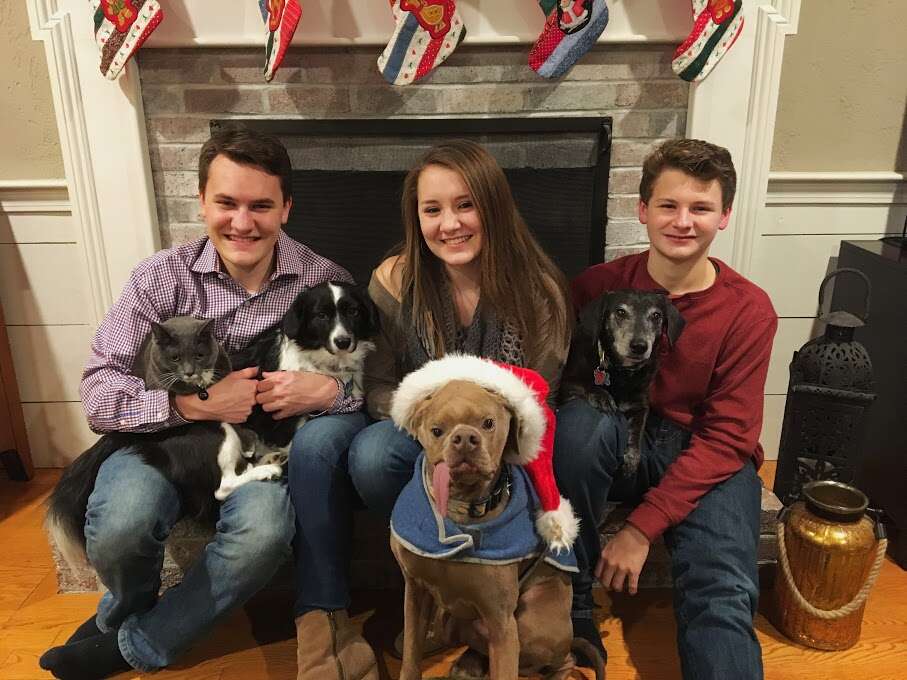 Family picture with dog in Santa hat