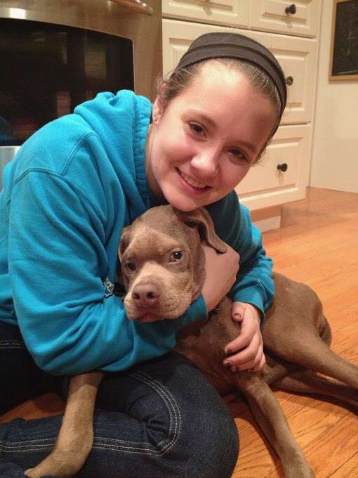 Young woman hugging dog