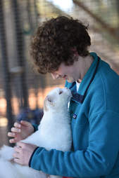 Woman looking down at cuddly cat