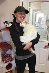 Woman holding snuggly cat