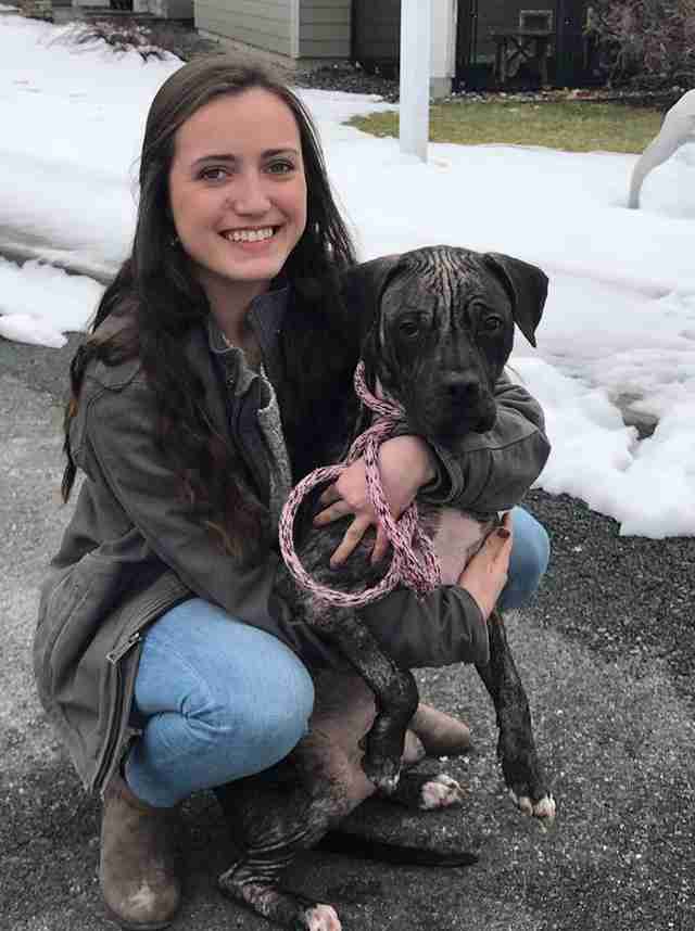 Woman hugging shelter dog outside