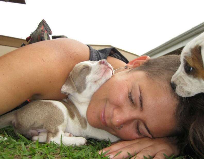 Woman cuddling with tiny puppy