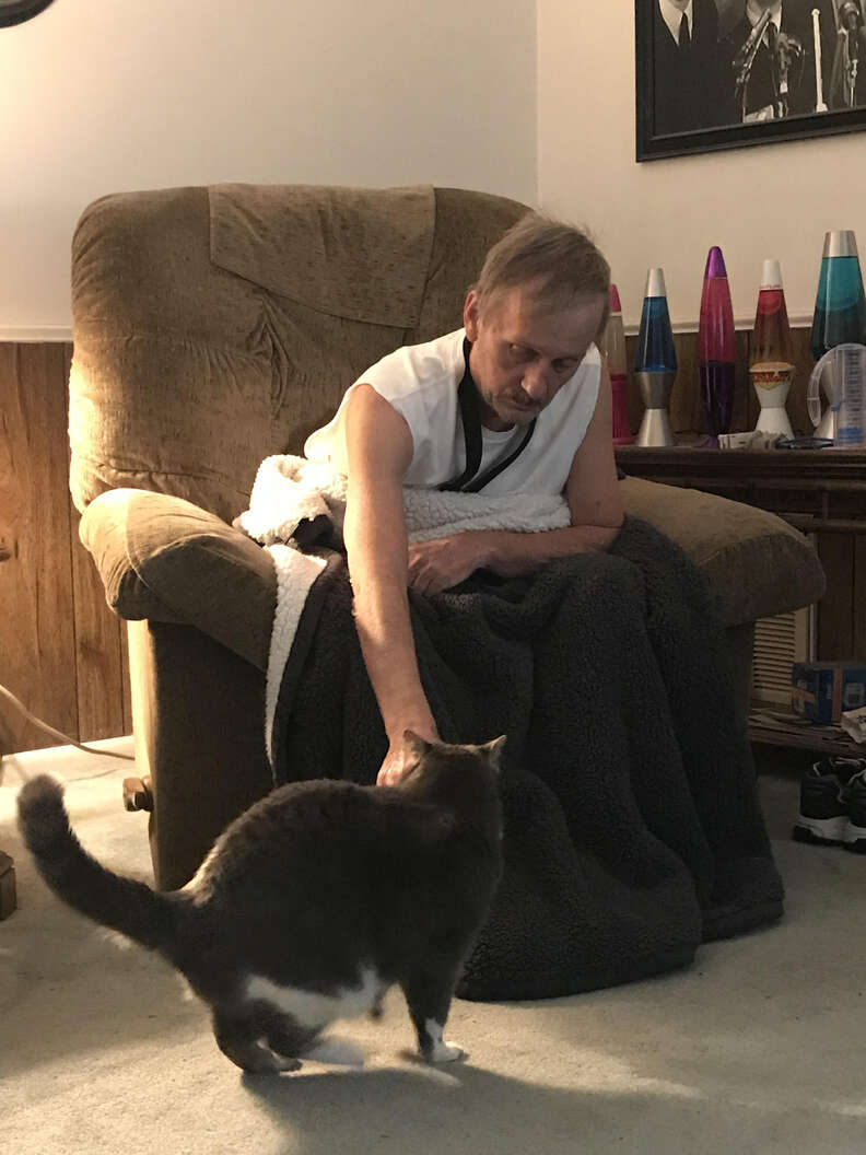 Man petting cat