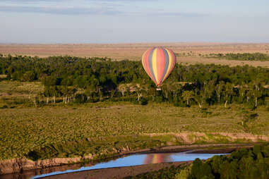 A hot air balloon soars above the African plains 