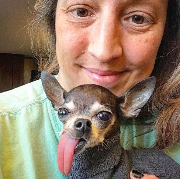 Woman snuggling with dog