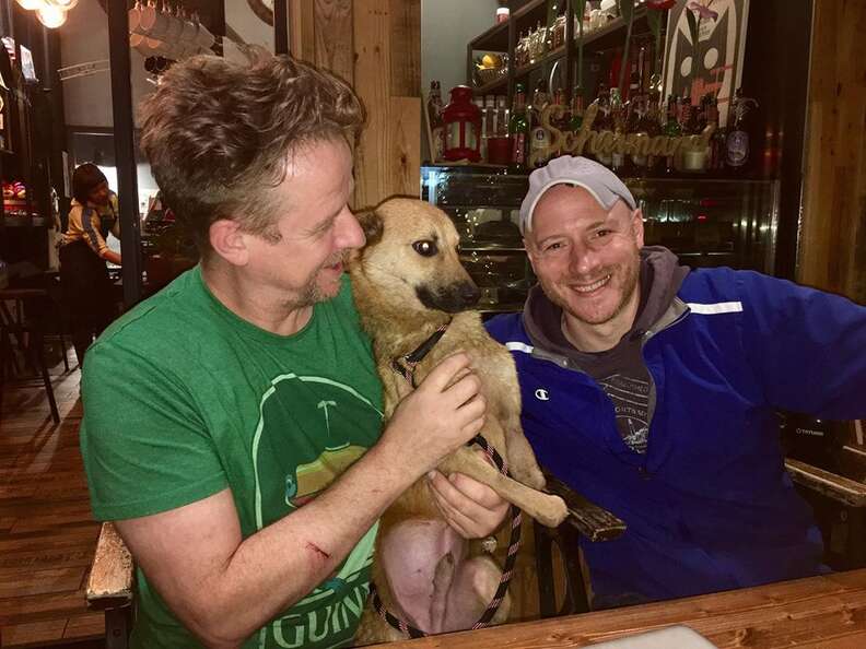 Two men with dog at pub