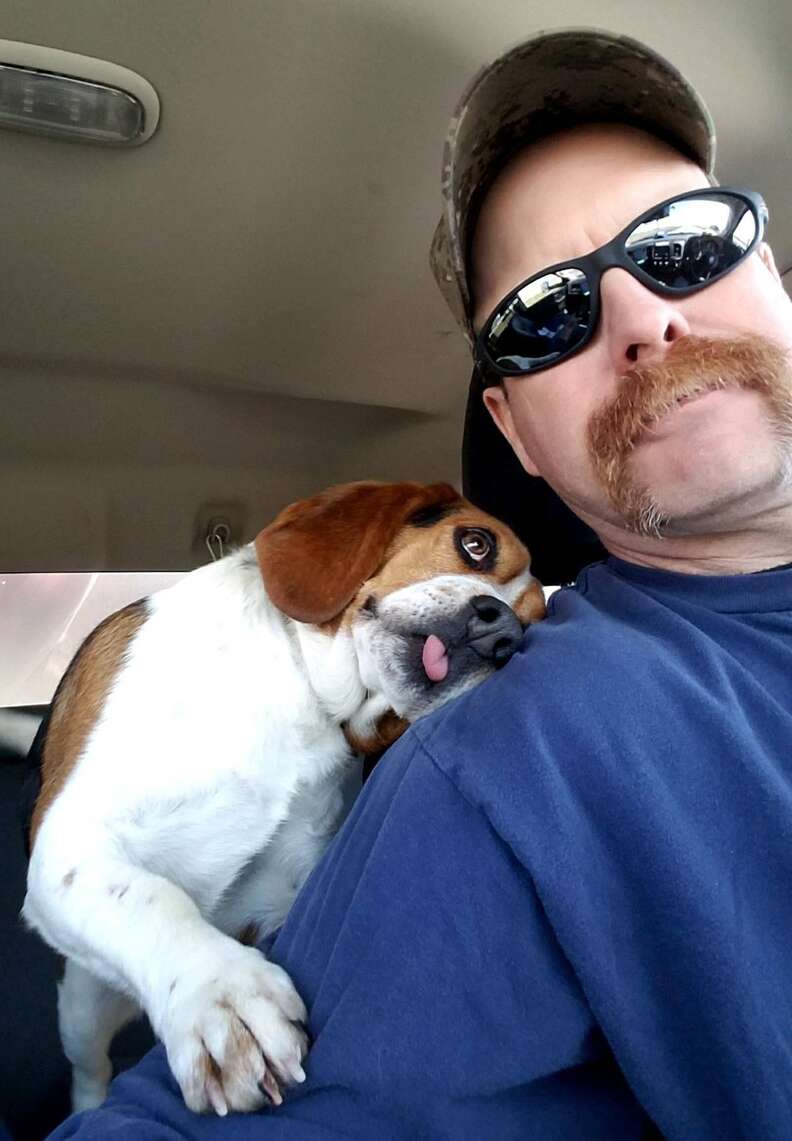 Gregory the dog snuggles his rescuer on his Freedom Ride