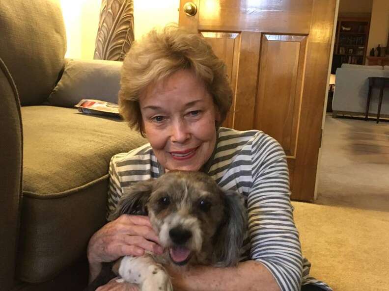 Older lady holding dog in her arms