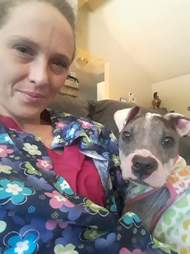 Woman holding puppy with mange