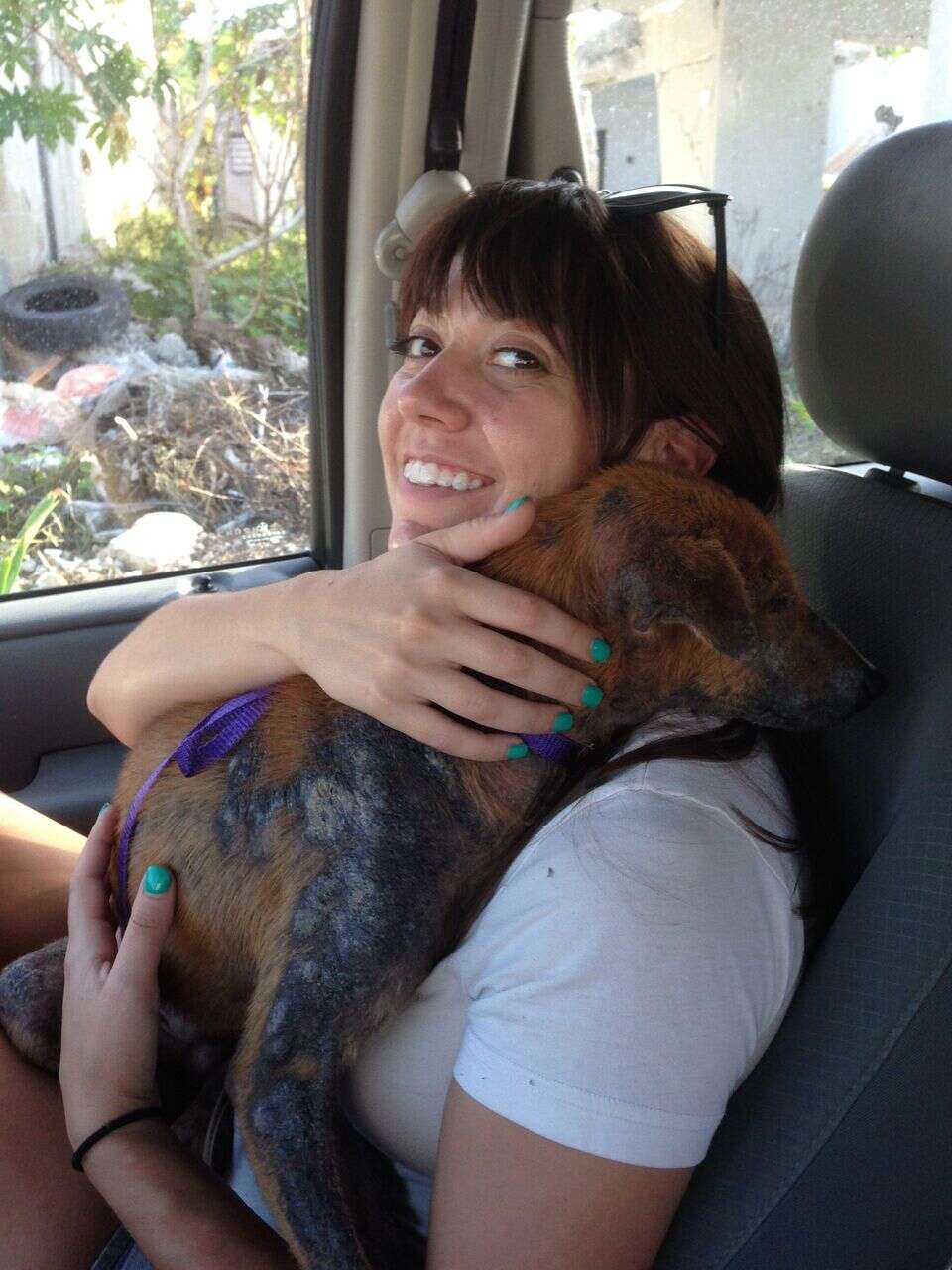 Woman holding dog in her arms