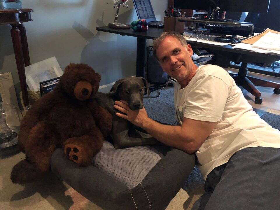 Man sitting on floor with dog