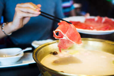 raw meat dipped into hot pot beef hotpot chinese lunar new year soup broth how to guide