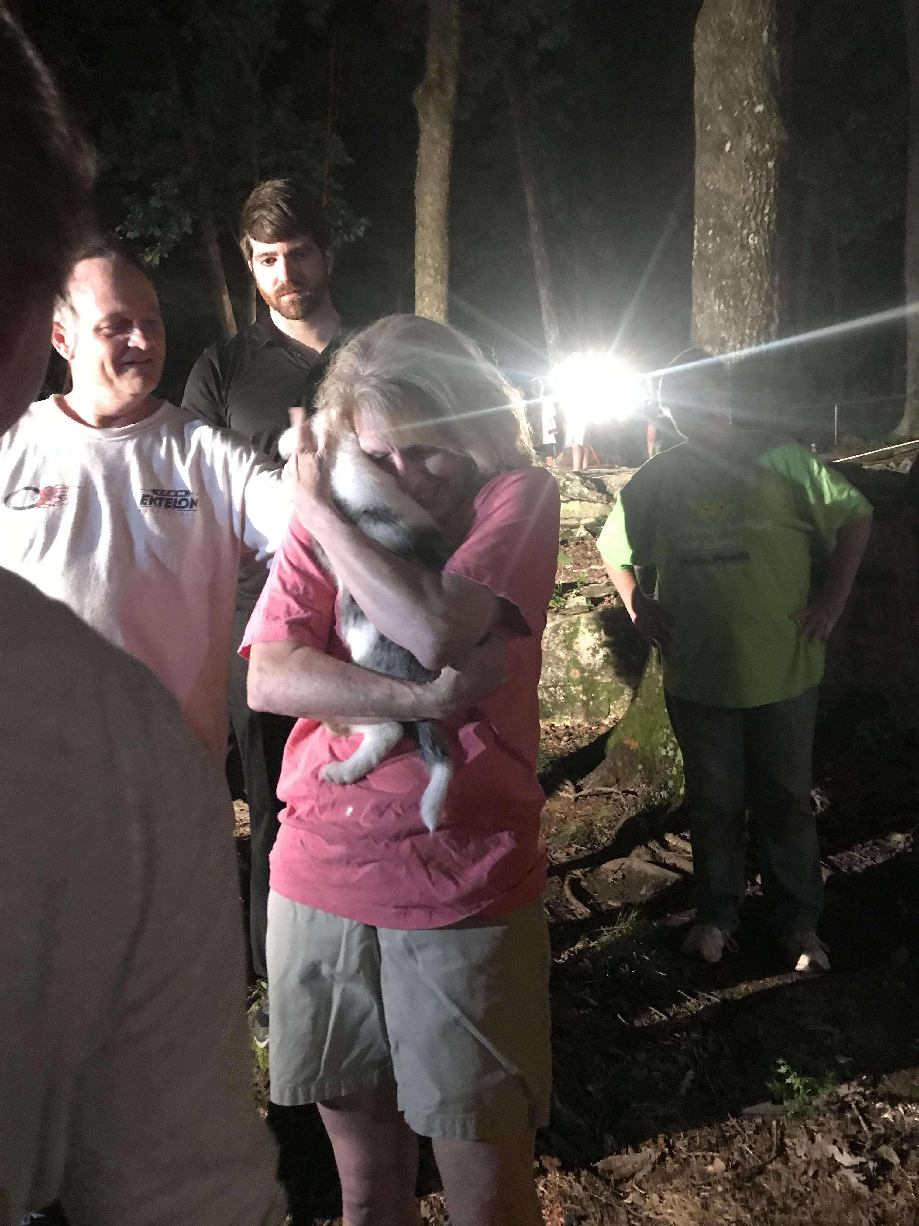 Woman holding puppy after she was rescued