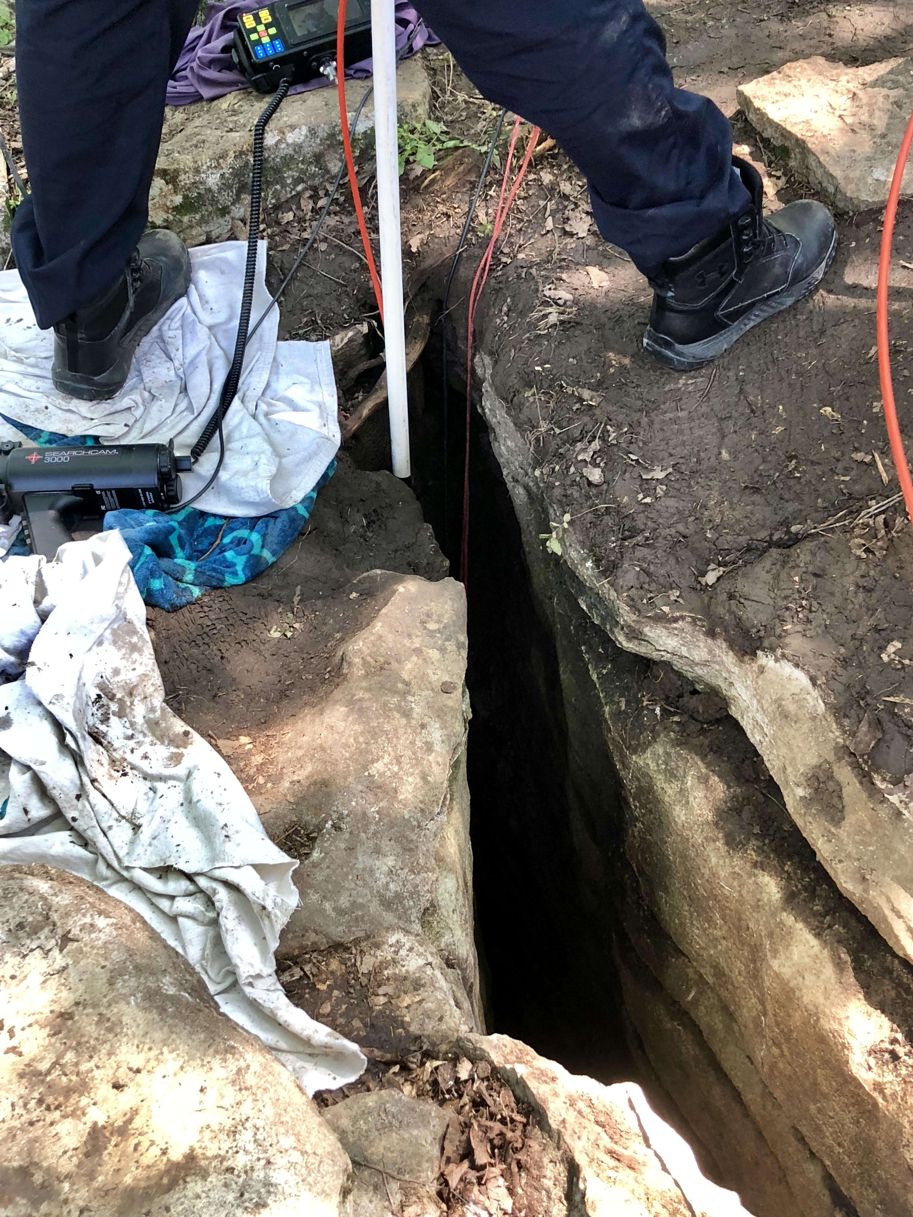 Rescuers trying to reach puppy at bottom of hole