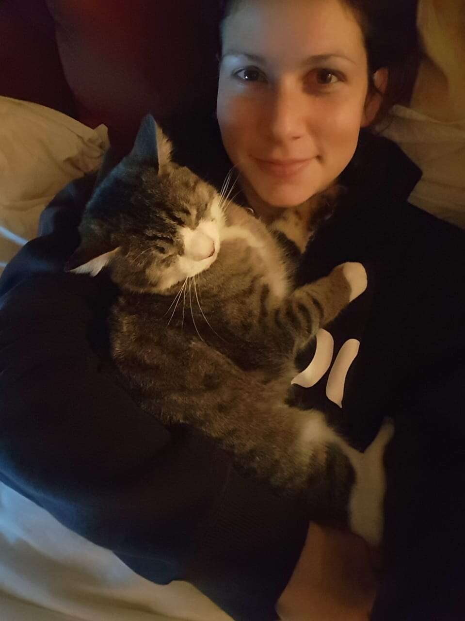 Woman cuddling with cat