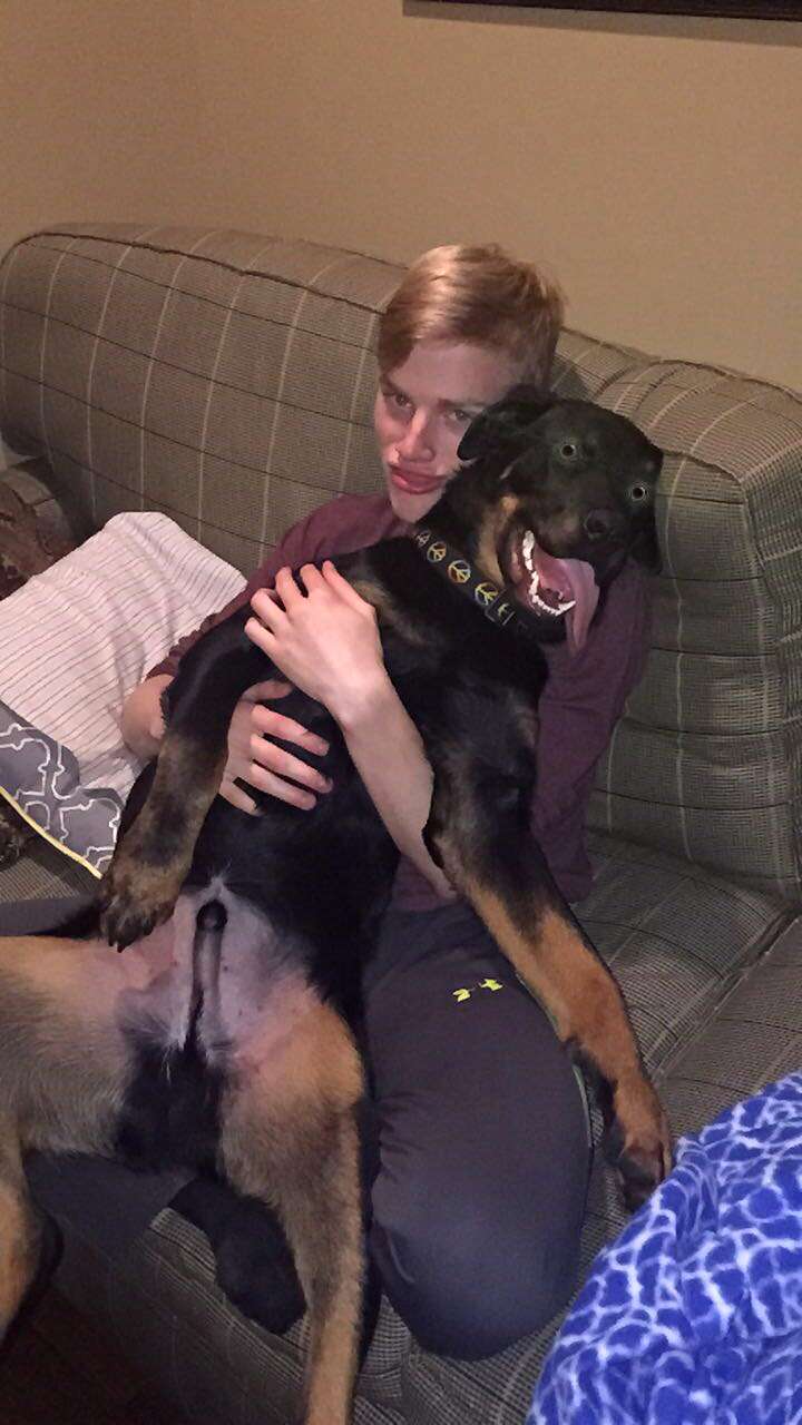 Dog cuddling with boy