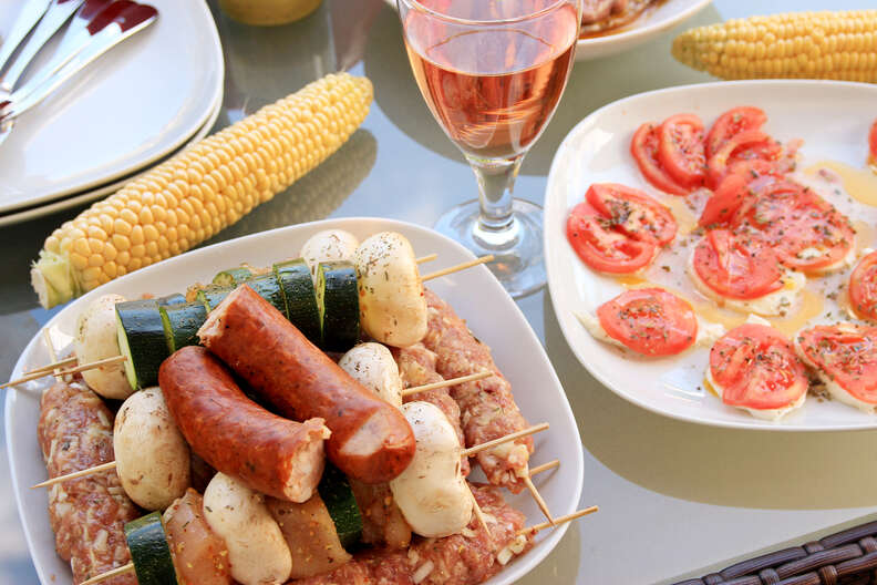 sausage, corn on the cobb, and rosé