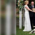 Dog rolling around on ground next to wedding couple