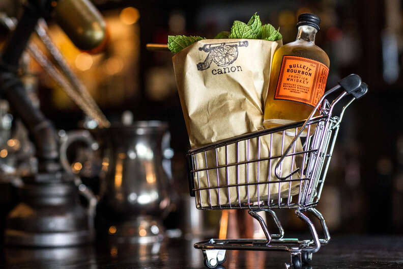 Canon Seattle cocktail bar bourbon bottle in mini grocery cart