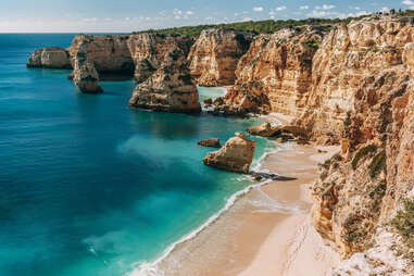 a beach flanked by jaw-dropping cliffs 