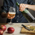 hands pouring cider