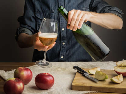 hands pouring cider
