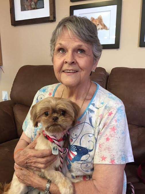 Older woman holding newly adopted dog