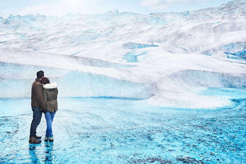 Couple in front of Mendenhall Glacier snowdrift