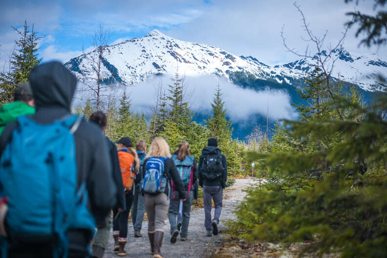 group hiking in front of mountain