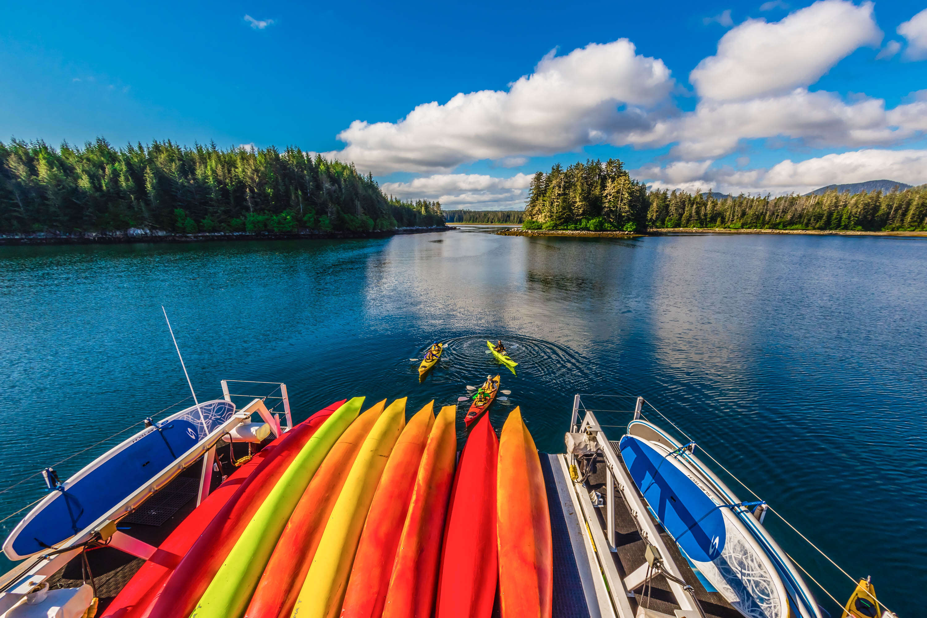 Kayaks stacked on stern of larger boat, Inside Passage, southeast Alaska